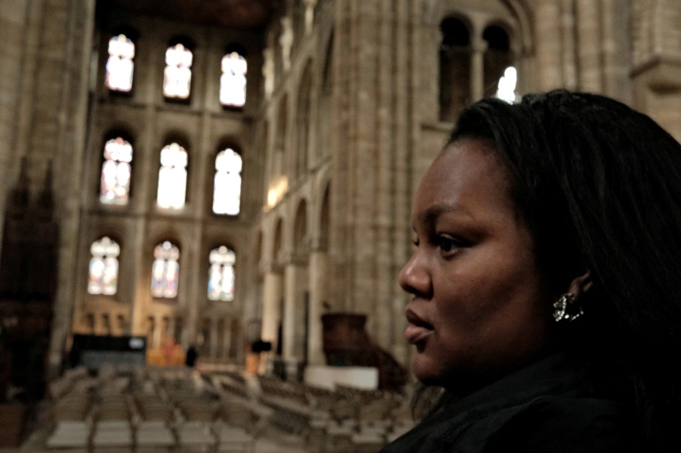 Jessica Nyassa in the nave of a Romanesque cathedral