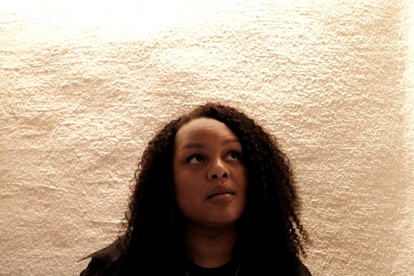 Jessica Nyassa against a sandstone wall